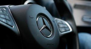 Mercedes-Emblem auf dem Lenkrad eines Autos.